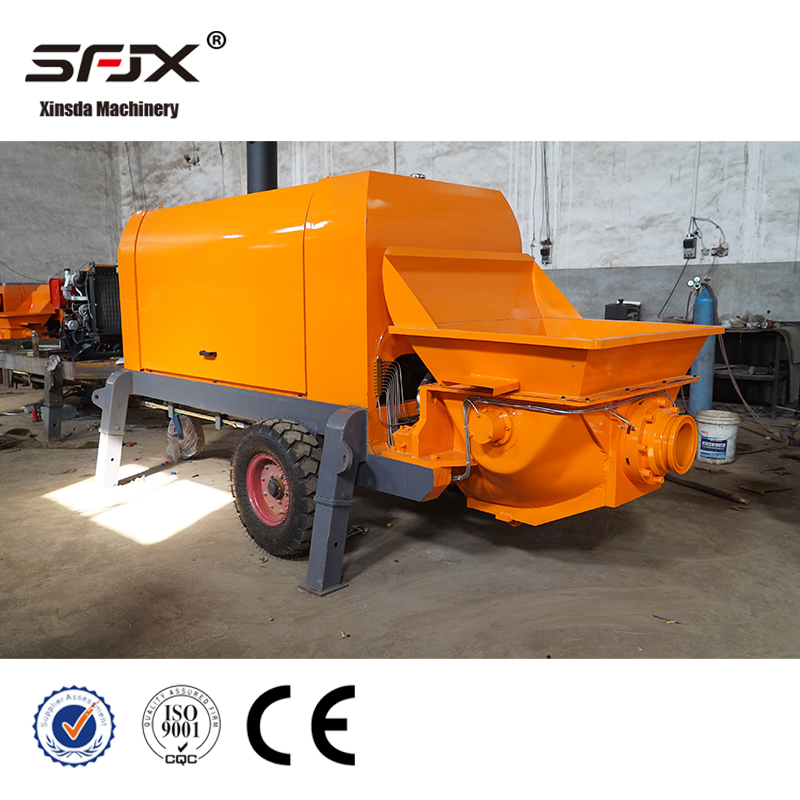 Orange concrete transfer pump with closed cover photographed in the factory