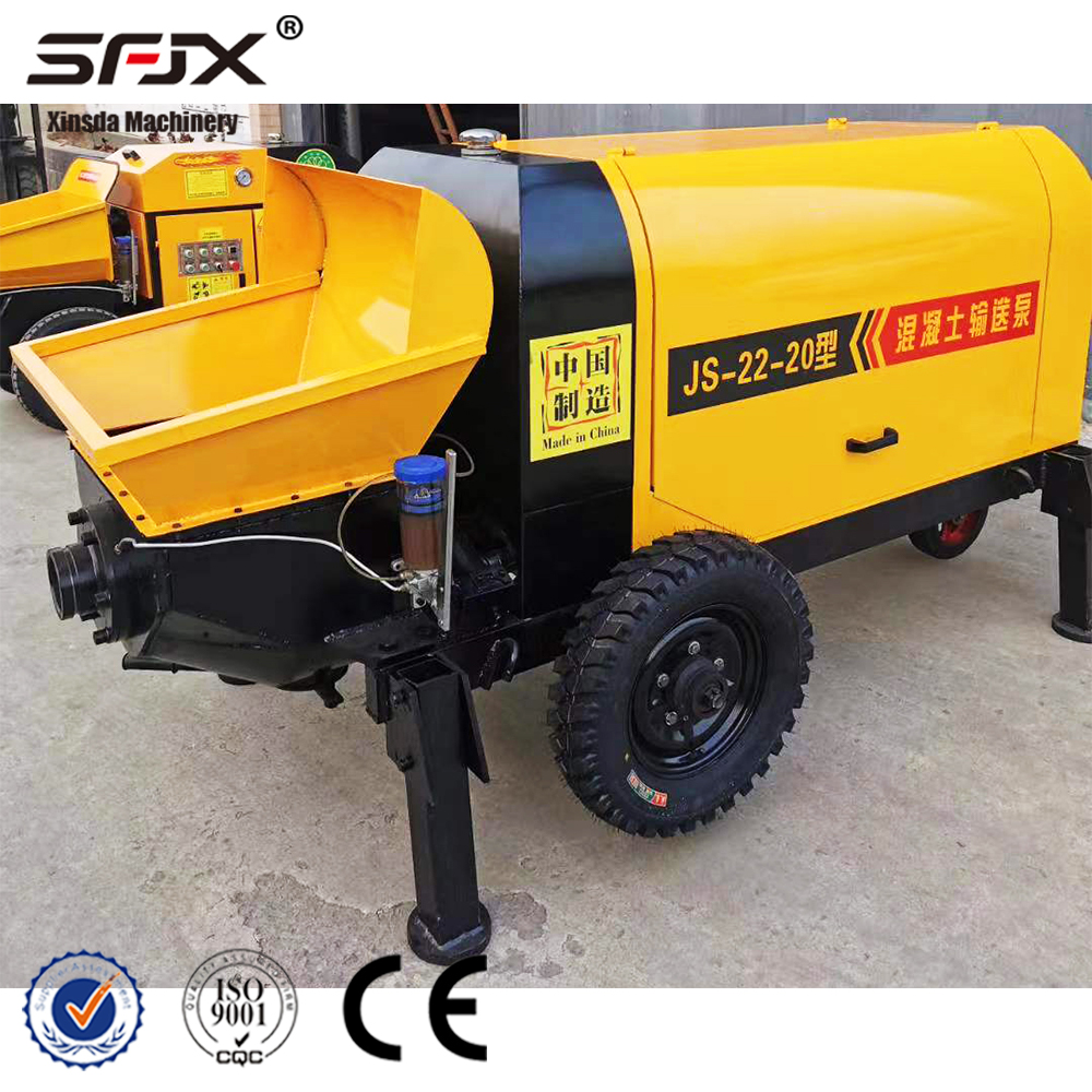 Yellow concrete pump labelled JS-22-20 with hopper and support legs