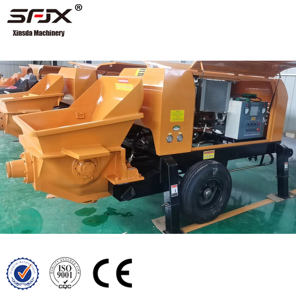 Orange concrete pump with cover open showing the cooling and electrical control assemblies